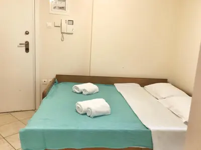 a hospital bed with two rolled towels on it at Seaview 2nd flr. apt. next to the beach, wifi,a/c,p/c media. in Anavissos