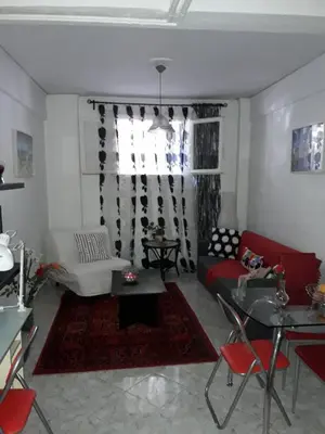 a living room with a red couch and a table at Αnna's Home!!!Holidays in beautiful Athens in Athens