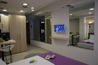 a hospital room with a bed and mirrors at Aiolos Apartments Suites Ermou 64 Monastiraki Plaka 2nd Floor in Athens