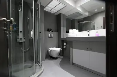 a bathroom with a shower and a toilet and a sink at Aiolos Apartments Suites Ermou 64 Monastiraki Plaka 2nd Floor in Athens