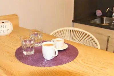 a table with two cups of coffee on a purple plate at Aiolos Apartments Suites Ermou 64 Monastiraki Plaka 2nd Floor in Athens