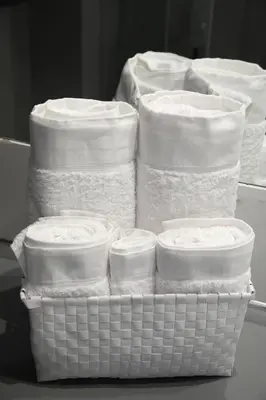 a stack of white towels in baskets on a table at Aiolos Apartments Suites Ermou 64 Monastiraki Plaka 2nd Floor in Athens