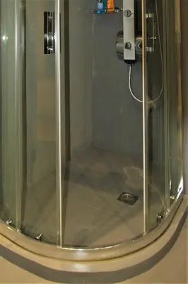 a shower with a glass door with a camera at Aiolos Apartments Suites Ermou 64 Monastiraki Plaka 2nd Floor in Athens
