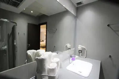 a bathroom with a sink and a mirror at Aiolos Apartments Suites Ermou 64 Monastiraki Plaka 2nd Floor in Athens