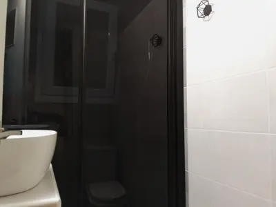 a bathroom with a shower and a white toilet at Athens Pangrati modern apt 10min to metro in Athens