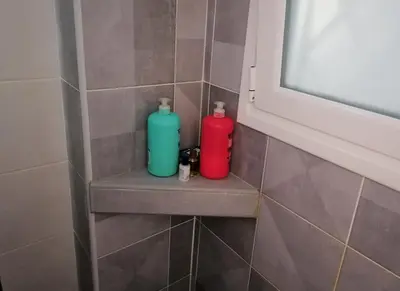 two bottles sitting on a shelf in a bathroom at Athens Pangrati modern apt 10min to metro in Athens
