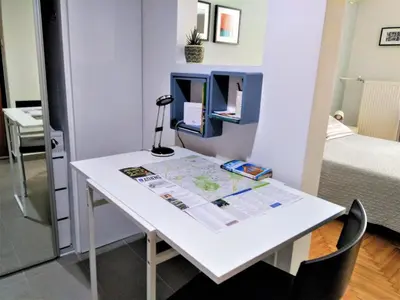 a room with a white desk with a map at Athens Pangrati modern apt 10min to metro in Athens