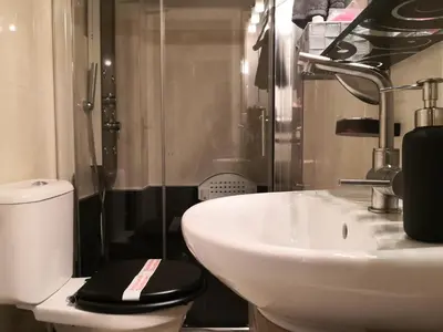 a bathroom with a white sink and a toilet at Luxury Home in Spáta