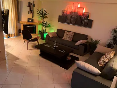 a living room with a couch and a table at Luxury Home in Spáta