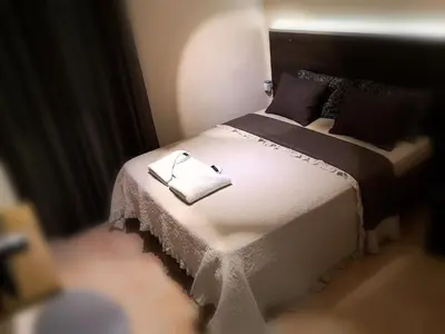 a bedroom with a bed with two towels on it at Luxury Home in Spáta