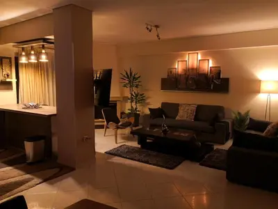 a living room with a couch and a table at Luxury Home in Spáta
