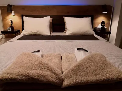 a large bed with three towels on it at Luxury Home in Spáta
