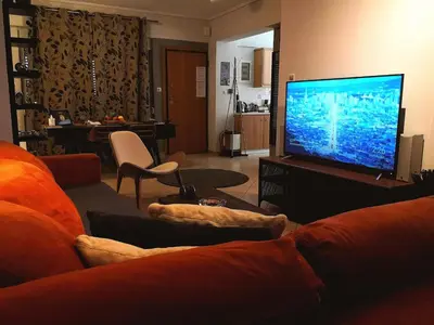 a living room with a large television and a couch at Luxury Home in Spáta