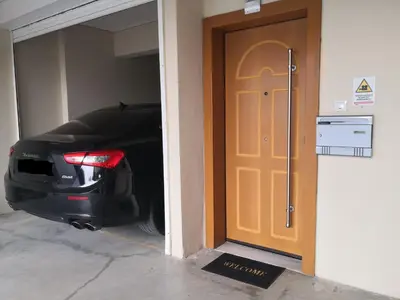 a car parked in a garage next to a door at Luxury Home in Spáta