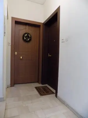 a hallway with a door with a wreath on it at George's Apartment in ''Pedion Areos'' area in Athens