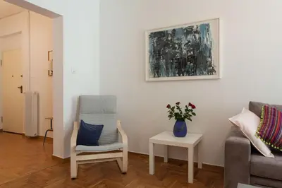 a living room with a chair and a couch at 2 bdrm apt for up to 6 guests next to Acropolis museum in Athens