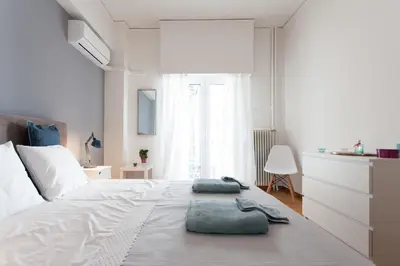 a bedroom with a bed with two towels on it at 2 bdrm apt for up to 6 guests next to Acropolis museum in Athens