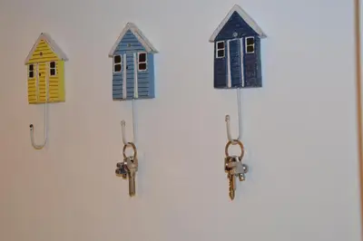 a group of small houses hanging on a wall at Vouliagmeni seaside flat in Athens