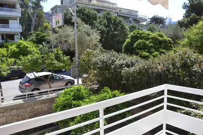 a car driving down a road in a city at Vouliagmeni seaside flat in Athens