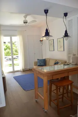 a living room with a table and a couch at Vouliagmeni seaside flat in Athens