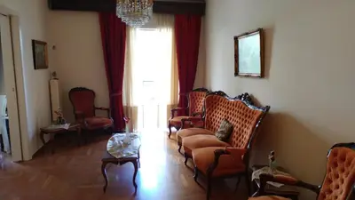 a living room with a couch and chairs and a table at Proteus Apartment in Athens