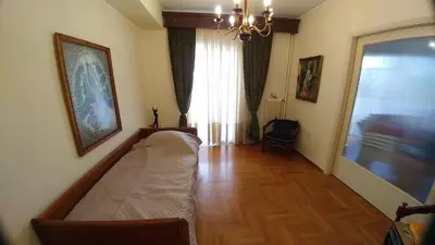 a living room with a couch and a large window at Proteus Apartment in Athens