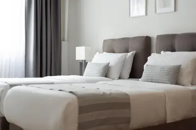 two white beds in a room with a large window at Syntagma Spotlight Residence in Athens