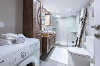 a bathroom with a washing machine and a shower at Piraeus Port Marouso in Piraeus
