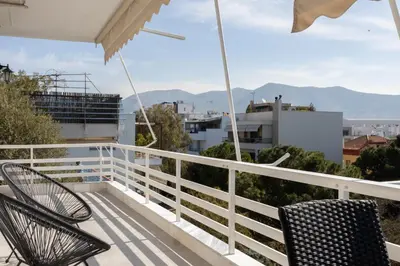 a balcony with two chairs and a view of the city at Luxurious 3-Bedroom Seaside Retreat Fully Renovated in 2025 in Athens