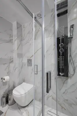 a white bathroom with a toilet and a shower at Luxurious 3-Bedroom Seaside Retreat Fully Renovated in 2025 in Athens