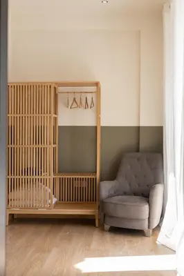 a living room with a chair and a crib at Luxurious 3-Bedroom Seaside Retreat Fully Renovated in 2025 in Athens