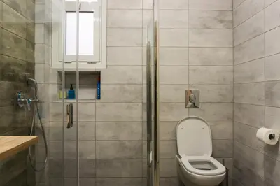 a bathroom with a toilet and a shower at Comfort Zone Apartment in the heart of Athens in Athens
