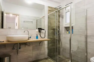 a bathroom with a sink and a shower at Comfort Zone Apartment in the heart of Athens in Athens