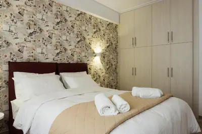 a bedroom with a large bed with towels on it at Comfort Zone Apartment in the heart of Athens in Athens