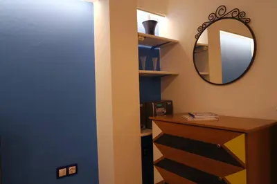 a bathroom with a blue door and a mirror at ATHENS *BLUE GRAND SUITE *DI GIORGIO CENTRAL APARTMENT in Athens