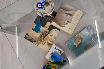 a table with pictures and a clock on it at ATHENS *BLUE GRAND SUITE *DI GIORGIO CENTRAL APARTMENT in Athens