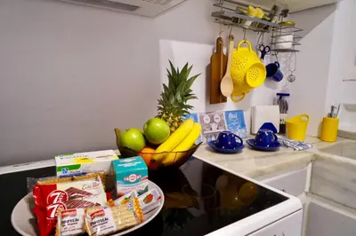 a kitchen with a bowl of fruit on a counter at ATHENS *BLUE GRAND SUITE *DI GIORGIO CENTRAL APARTMENT in Athens