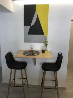 a table with two chairs and a painting on the wall at ATHENS *BLUE GRAND SUITE *DI GIORGIO CENTRAL APARTMENT in Athens
