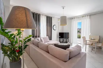 a living room with a couch and a table at Luxury Apt Near The Airport in Spáta