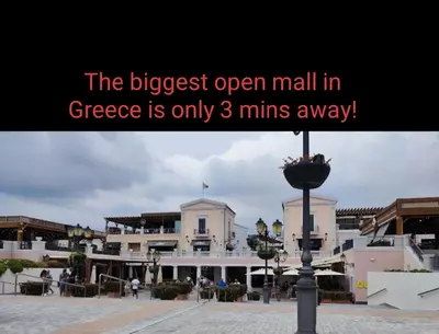 a sign that reads the biggest open mall in greece is only mins at Luxury Apt Near The Airport in Spáta