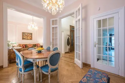 a dining room with a table and blue chairs at The Rare Luxury Gem in Kolonaki Sq - near Syntagma in Athens