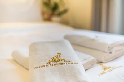 a pile of white towels sitting on a bed at The Rare Luxury Gem in Kolonaki Sq - near Syntagma in Athens