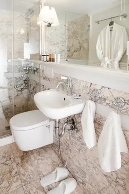 a white bathroom with a sink and a mirror at The Rare Luxury Gem in Kolonaki Sq - near Syntagma in Athens