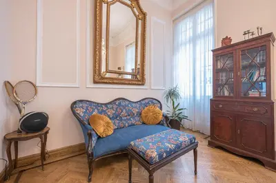 a living room with a blue couch and a mirror at The Rare Luxury Gem in Kolonaki Sq - near Syntagma in Athens