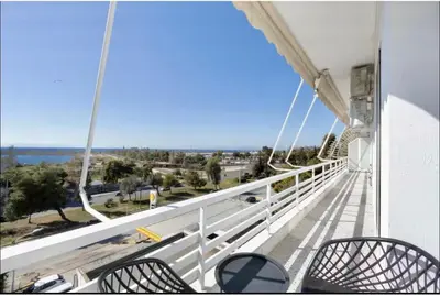 a balcony with chairs and a view of the ocean at Glyfada Panoramic Seaview Penthouse in Athens