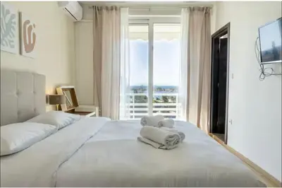 a bedroom with a bed with a teddy bear on it at Glyfada Panoramic Seaview Penthouse in Athens