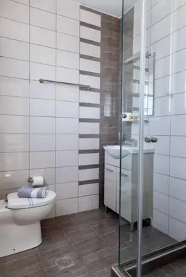 a bathroom with a shower and a toilet and a sink at Glyfada Panoramic Seaview Penthouse in Athens