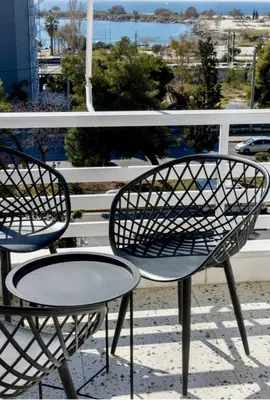 two chairs and a table on a balcony at Glyfada Panoramic Seaview Penthouse in Athens