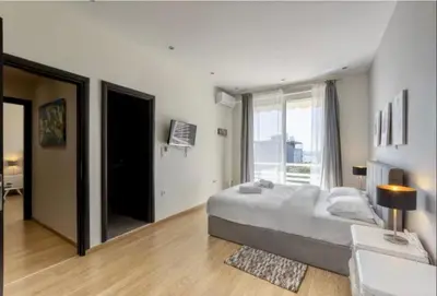 a bedroom with a large bed and a large window at Glyfada Panoramic Seaview Penthouse in Athens