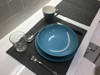 a blue plate and a cup on a table at El Pacífico in Athens